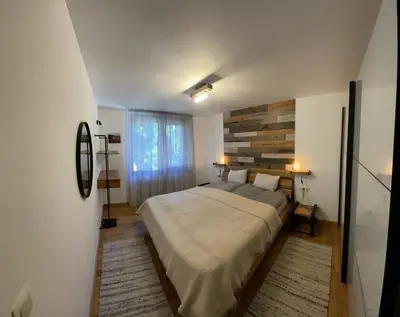 a bedroom with a large bed and a window at Borovets Boutique Apartment Sequoia II in Borovets
