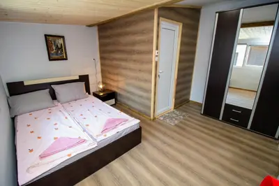 a bedroom with a bed with a wooden wall at Swan7 Studios in Plovdiv