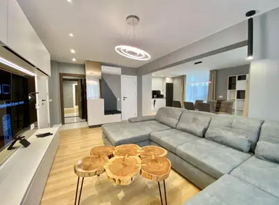 a living room with a couch and two tables at Gran Capital - Vodolei Park, FREE parking in Sofia