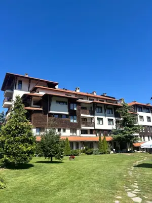 a large apartment building with a green lawn in front of it at View Apartment Bansko Royal Towers in Bansko