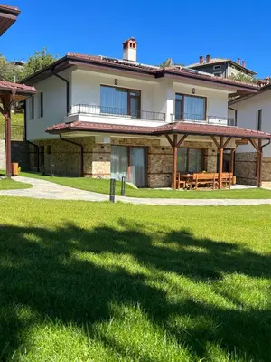 a house with a large yard in front of it at SPA Apartament Daffi in Smolyan