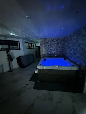 a large bathroom with a tub with a blue lighting at The Hillside Villa in Ognyanovo