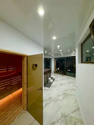two views of a room with a hallway with marble floors at The Hillside Villa in Ognyanovo