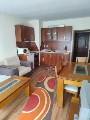 a small living room with a couch and a table at Apartment near by Studenec-Cedar Heights 1 in Pamporovo