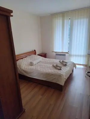 a bedroom with a bed with two towels on it at Apartment near by Studenec-Cedar Heights 1 in Pamporovo