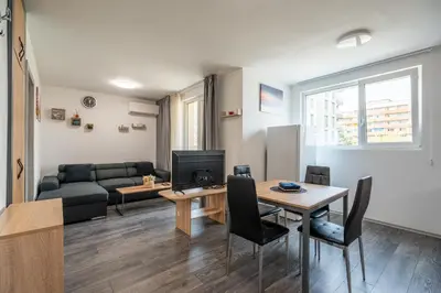 a living room with a couch and a table at Cardinal Suite in Sofia