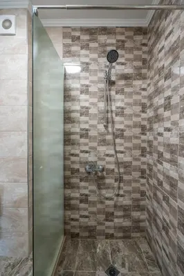 a shower with a glass door in a bathroom at Cardinal Suite in Sofia