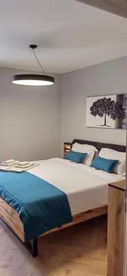 a bedroom with a large bed with blue pillows at Apartmenthaus Oborishte - 24 in Panagyurishte