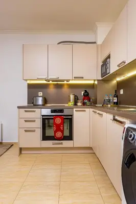 a kitchen with white cabinets and an oven at Yanevi Apartments at Grand Monastery Pamporovo in Pamporovo
