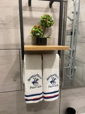 a towel rack in a bathroom with two towels at Бутиково студио Joy-free parking in Plovdiv