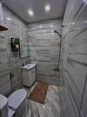 a bathroom with a shower and a toilet and a sink at Бутиково студио Utopia in Plovdiv