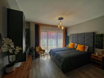 a bedroom with a bed and a large window at Бутиково студио Utopia in Plovdiv