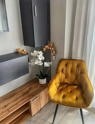 a brown leather chair in a living room with a television at Бутиково студио Utopia in Plovdiv