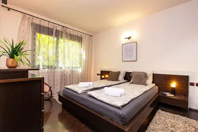 a bedroom with a large bed and a window at Quiet Apartment in Plovdiv Ricky Home in Plovdiv