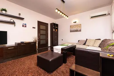 a living room with a couch and a tv at Quiet Apartment in Plovdiv Ricky Home in Plovdiv