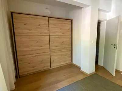 a large sliding door in a room with wood at Удобен апартамент в центъра на София in Sofia