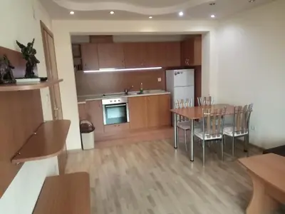 a kitchen and dining room with a table and chairs at Apartments Center in Sandanski