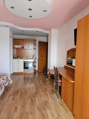 a living room with a kitchen and a dining room table at Apartments Center in Sandanski