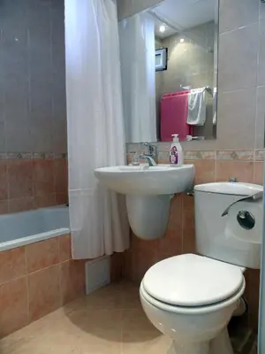 a bathroom with a white toilet and a sink at Apartments Center in Sandanski