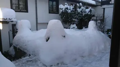 a pile of snow in front of a house at Matsureva House - Pri Ivan in Bansko