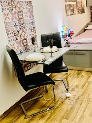 a table and two chairs in a room at Little Paris with Free Garage Near Tokuda Hospital in Sofia