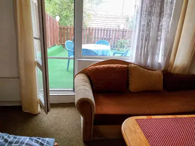a living room with a couch and a sliding glass door at Zodiac House in Samokov