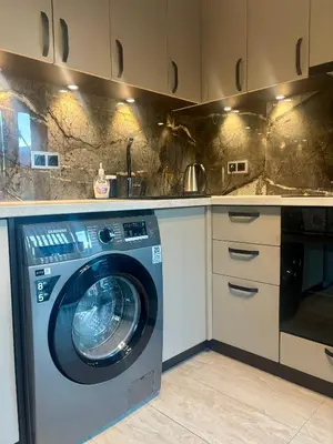 a kitchen with a washing machine in a kitchen at Business Park Sofia Cozy Lux & Private Garage Option in Sofia