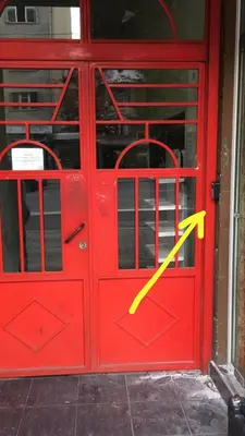 a red door with a yellow arrow on it at Скобелев 48 in Sofia