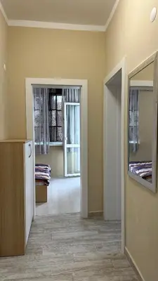 a room with a room with two beds and a hallway at Скобелев 48 in Sofia