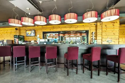 a bar with red chairs at a restaurant at Bansko Cozy Peak in Bansko