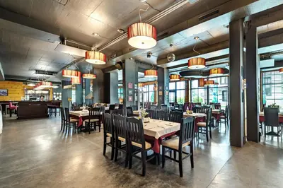 a dining room with tables and chairs and chandeliers at Bansko Cozy Peak in Bansko