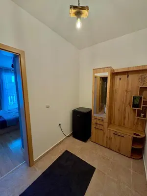 an empty room with a room with a table and a door at Bansko Cozy Peak in Bansko