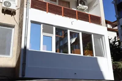 a white garage door with windows on a building at Apartment Nataliya in Smolyan