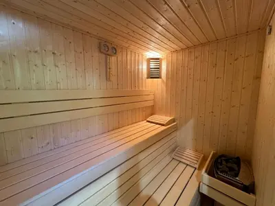 an empty wooden sauna with a light in it at Къща за гости Лъките in Divchovoto
