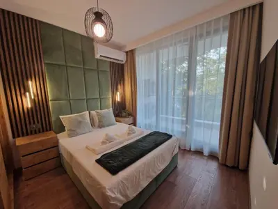 a bedroom with a bed and a large window at Sun Home in the Heart of Plovdiv - Central Location - Free Private Parking in Plovdiv