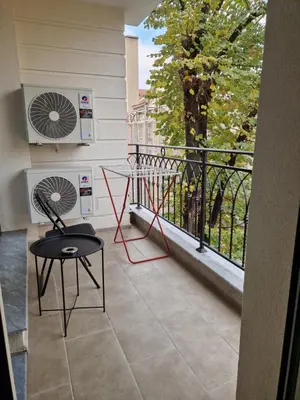 a balcony with a table and a fan at Sun Home in the Heart of Plovdiv - Central Location - Free Private Parking in Plovdiv