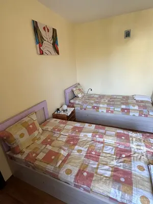 two beds sitting next to each other in a room at Tainov House in Samokov