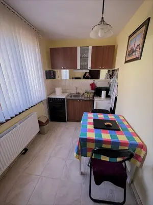 a kitchen with a table with a colorful table cloth on it at Tainov House in Samokov