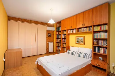 a bedroom with a bed and book shelves at Vintage and Cozy 2BD Apartment in Prime Location by Flat Mаnager in Sofia