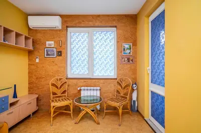 a room with chairs and a table and a window at Vintage and Cozy 2BD Apartment in Prime Location by Flat Mаnager in Sofia