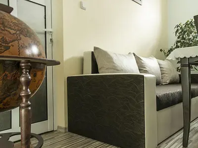 a living room with a couch and a table at АПАРТАМЕНТ ЗА ГОСТИ 