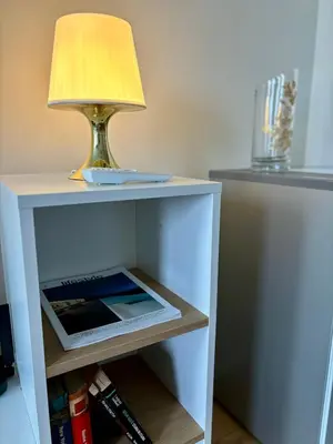 a table with a lamp and a tablet on it at MyCampus UNWE Studentski Mountain Views Modern Kitchen Equipment in Sofia