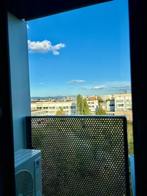 a window with a view of a city with buildings at MyCampus UNWE Studentski Mountain Views Modern Kitchen Equipment in Sofia