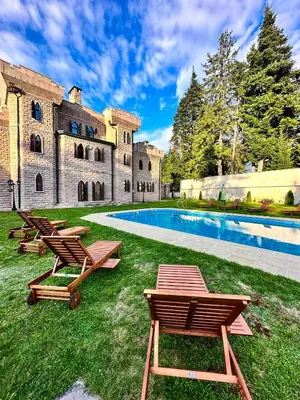 a row of lounge chairs in front of a building at The Castle - Your unique way of retreat in Borovets