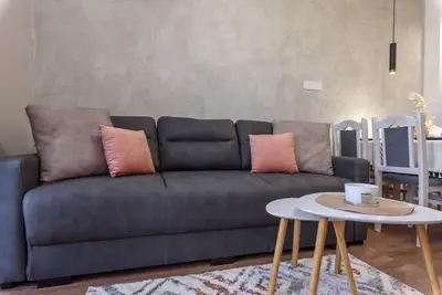 a living room with a couch and a table at Vutovi's corner made with care in Bansko