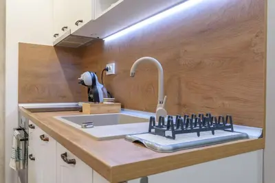 a kitchen counter with a sink and a faucet at Vutovi's corner made with care in Bansko