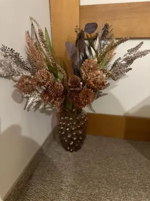 a vase with a bouquet of flowers in it at Cozy studio in Green Life Bansko in Bansko