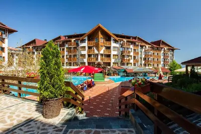 a resort with a pool and a large building at Pirin's Hidden Gem BB & SKI & SPA in Bansko