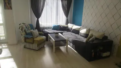 a living room with a couch and a chair at Apartment Sophie in Plovdiv