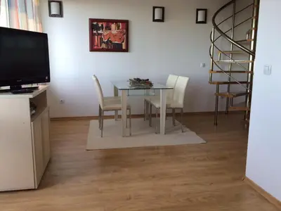 a dining room with a table and chairs at Stenata Boutique Apartments in Pamporovo